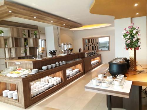 a kitchen with a counter with dishes on display at Infinity Hotel Jambi by Tritama Hospitality in Jambi