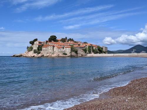 a house on an island in the water at Luxury Apartments Montesan in Sveti Stefan