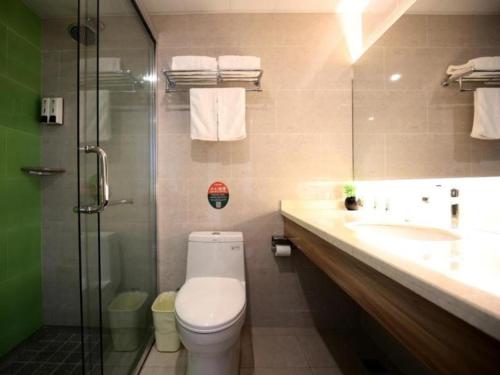 a bathroom with a toilet and a sink and a shower at GreenTree Inn Xuancheng Jingxian Wannan First Street Express Hotel in Jingxian