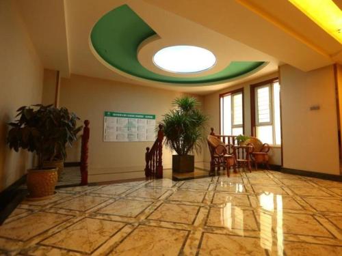 a room with a table and chairs and a green ceiling at GreenTree Inn Taiyuan East Binhe Road Xiaodian High speed mouth Express Hotel in Kao-chung-ts'un
