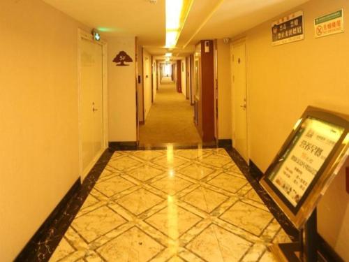 a hallway with a tile floor in a building at GreenTree Inn Taiyuan East Binhe Road Xiaodian High speed mouth Express Hotel in Kao-chung-ts'un