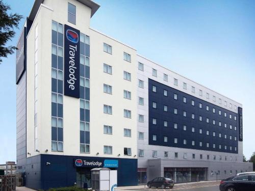 a large white building with a sign on it at Travelodge Birmingham Airport in Sheldon
