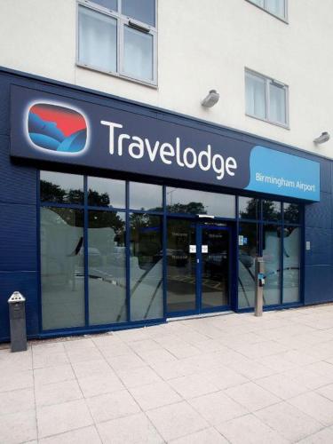 a travelodge sign on the side of a building at Travelodge Birmingham Airport in Sheldon