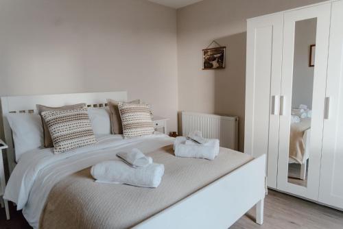 a bedroom with a white bed with towels on it at Cleod9 -Croft house at 9 Garenin in Carloway