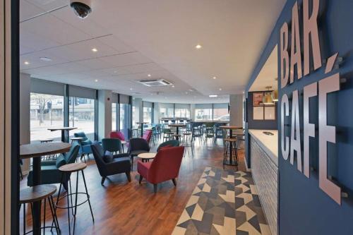 a restaurant with chairs and tables in a room at Travelodge London Hounslow in Hounslow
