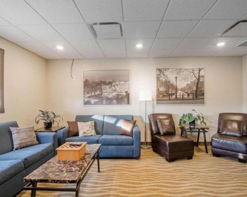 a living room with blue couches and chairs at Quality Inn and Suites - KindersLey in Kindersley
