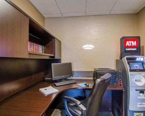 an office with a desk with a computer and a chair at Quality Inn and Suites - KindersLey in Kindersley