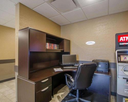 an office with a desk with a computer and a chair at Quality Inn and Suites - KindersLey in Kindersley