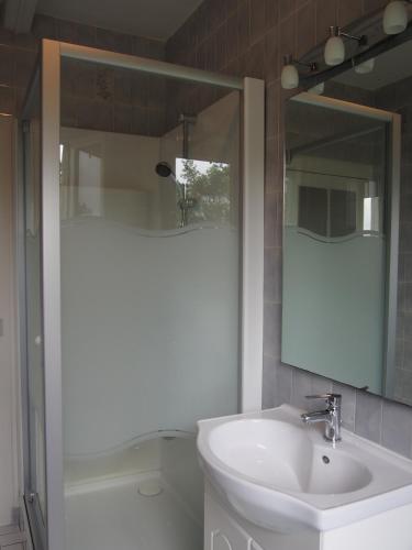 une salle de bain avec un lavabo et un miroir dans l'établissement St Michel, à Vains