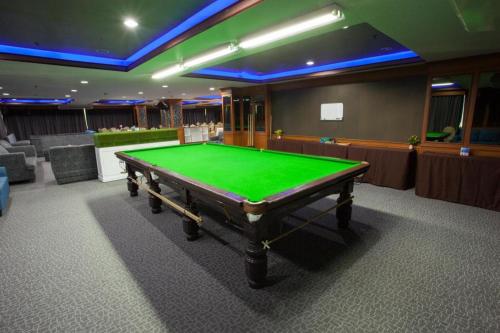 a green pool table in a gaming room at Aurora Bay Hotel in Bangna