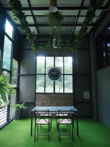 a table and two chairs in a room with a table at The Nest Hotel in Nakhon Ratchasima
