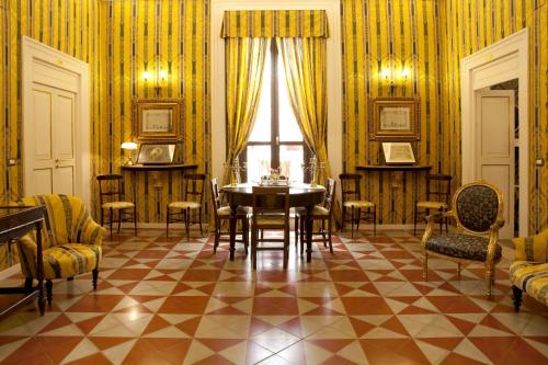 a dining room with a table and chairs at Palazzo Antica Via Appia in Bitonto