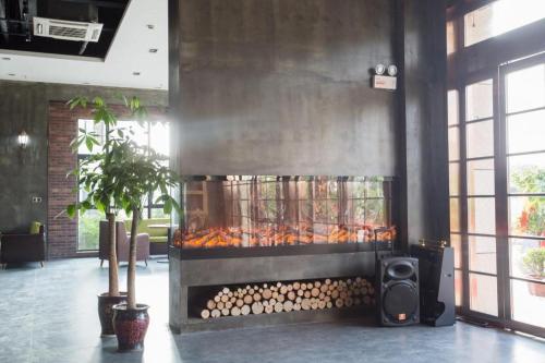 a fire place in a room with a bunch of logs at James Joyce Coffetel Wuhu Wanzhi High-Speed Railway Station in Liangzhongchang