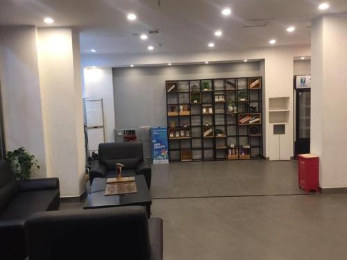 a waiting room with couches and chairs in a building at 7Days Inn Shenzhen Longgang Nanlian Metro Station Branch in Longgang