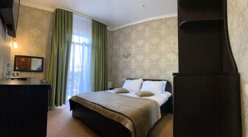 a hotel room with a bed and a sink at Курортний Готель Золота Корона in Truskavets