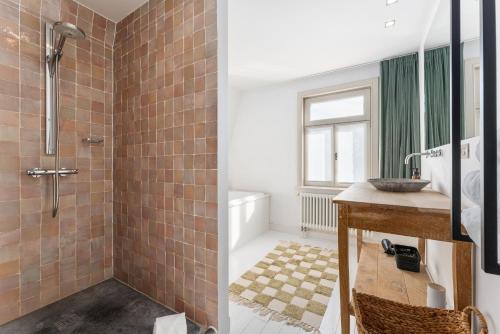 a bathroom with a shower and a sink at Magique 31 - Luxeverblijf met tuin & parking in Oostduinkerke