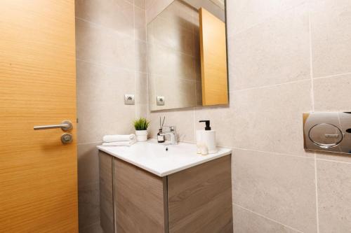 a bathroom with a sink and a mirror at Stylish 1BR flat in Hay Riad Central Rabat in Rabat