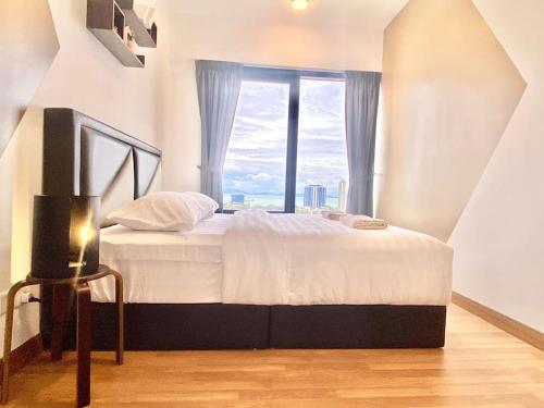 a bedroom with a large bed with a large window at Tropicana 218 Macalister #Seaview #Modern Retro #Infinity Pool #Georgetown #7pax #3BR 2bath #1King 2Queen 1Single #Quality well maintained #Private host in George Town