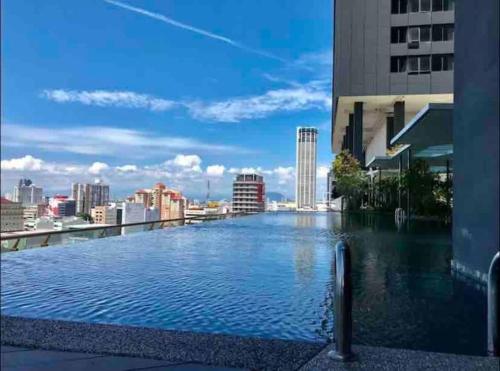 a swimming pool on the roof of a building at Tropicana 218 Macalister #Seaview #Modern Retro #Infinity Pool #Georgetown #7pax #3BR 2bath #1King 2Queen 1Single #Quality well maintained #Private host in George Town