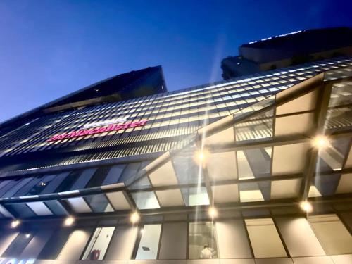 a tall building with lights on the side of it at Tropicana 218 Macalister #Seaview #Modern Retro #Infinity Pool #Georgetown #7pax #3BR 2bath #1King 2Queen 1Single #Quality well maintained #Private host in George Town