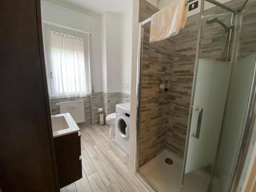 a bathroom with a shower and a toilet and a sink at Appartamento Burattino - Immobili e Soluzioni Rent in Bergamo