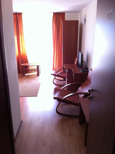 a room with chairs and a desk with a computer at JRB Hotel in Ştei