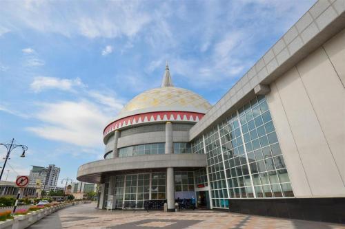 a building with a dome on top of it at Grand City Hotel in Kampong Gadong