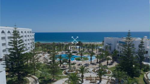 an aerial view of a resort with a pool and the ocean at Iberostar Selection Kantaoui Bay in Port El Kantaoui