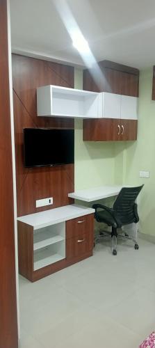 an office with a desk and a chair in a room at Xanadu studio Appartment 904 in kolkata