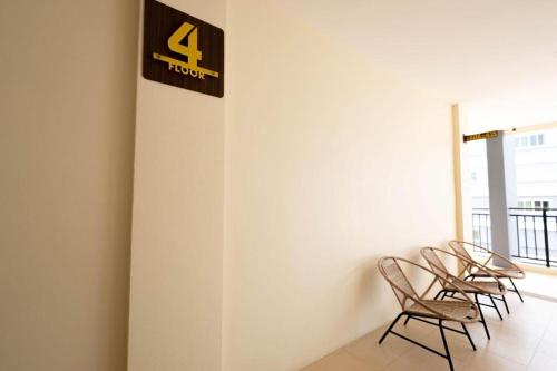 a group of chairs lined up against a wall at The Nest Krabi Hotel in Ao Nang Beach