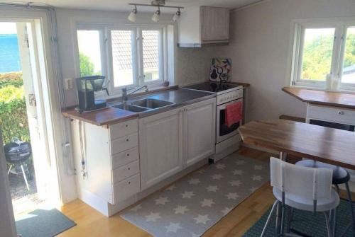a kitchen with a sink and a counter top at Cottage by the ocean in Ängelholm