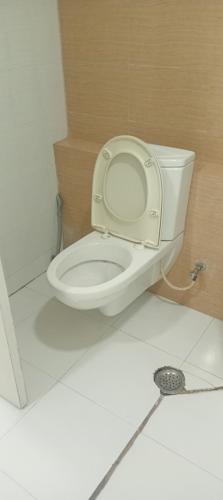 a bathroom with a toilet with the lid up at Xanadu studio Appartment 904 in kolkata