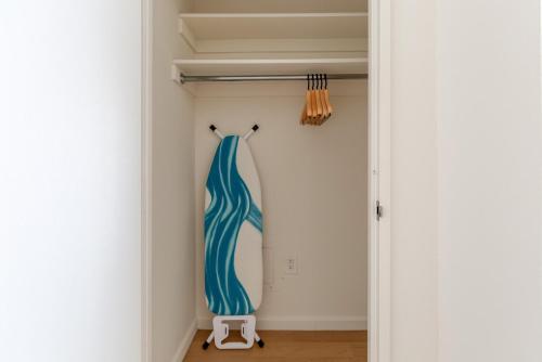 a closet with a blue dress hanging on a wall at Blueground UW gym doorman nr Central Park NYC-1441 in New York