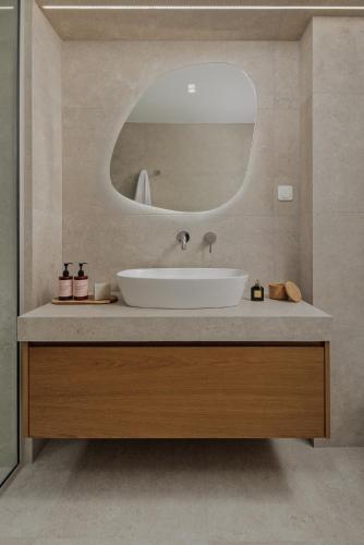 a bathroom with a sink and a mirror at Blanc Residences in Ioannina