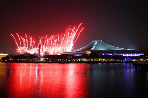 a large building with fireworks in the sky at night at South East Asia Hotel in Singapore