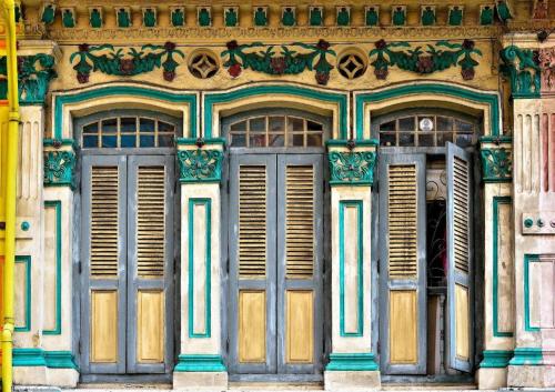 a building with blue doors and windows on it at South East Asia Hotel in Singapore