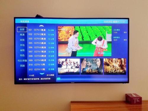 a flat screen tv hanging on a wall at PAI Hotels·Kangding Xiaqiao in Garze