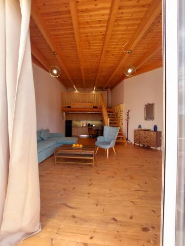 a living room with a couch and a table at Roza Stone Studio & Suite in Goníai