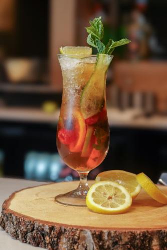 a drink in a vase sitting on a cutting board at Park hall Hotel & Spa Lancashire, a member of Radisson Individuals in Eccleston
