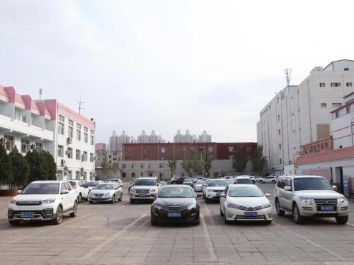 kilka samochodów zaparkowanych na parkingu w obiekcie Jinjiang Inn Select Wuhai Xinhua Street w Wuhai