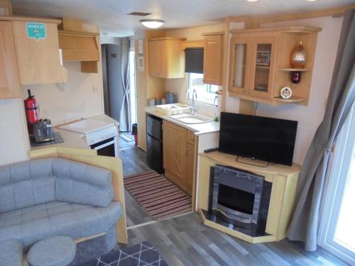 a kitchen and living room with a caravan at 6 berth 3 bedroom Northshore Skegness FREE WIFI in Skegness