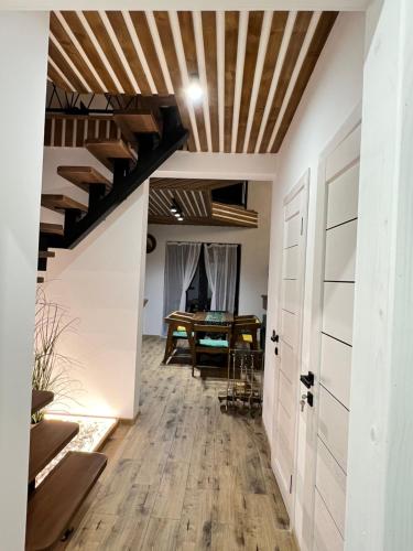 a hallway with a wooden ceiling and a table at Villa Pelahia in Slavske