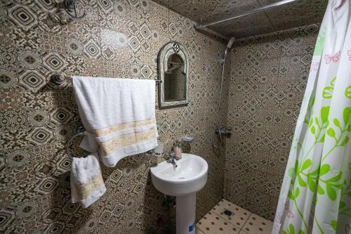 a small bathroom with a sink and a toilet at Riad Fes Lile in Fès