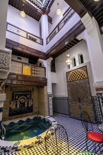 a large room with a pool in a building at Riad Fes Lile in Fès