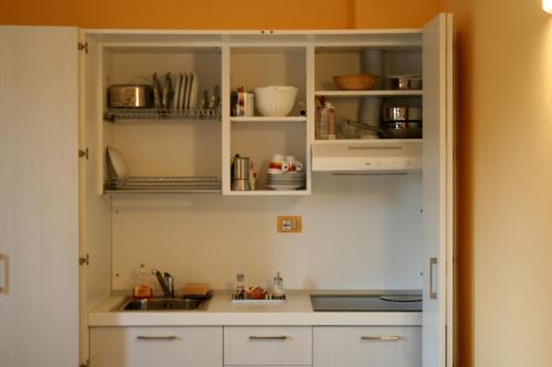 a kitchen with white cabinets and a sink at Agriturismo Argaland in Parma