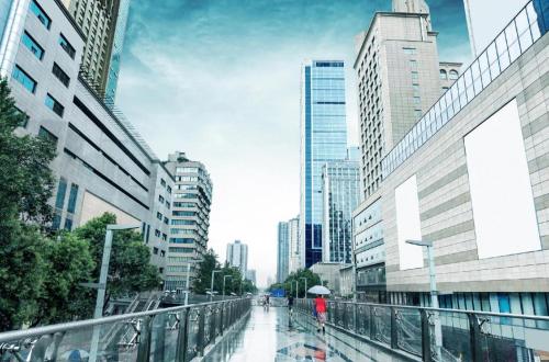 a person walking down a city street with an umbrella at James Joyce Coffetel·Chengdu Chunxi in Chengdu