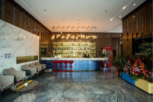 a lobby with a bar with chairs and a counter at Zmax Lhasa Potala Palace Square in Lhasa