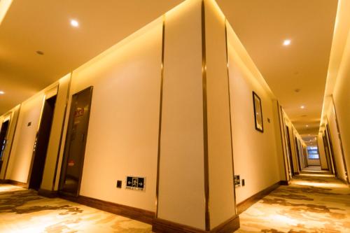 a hallway of a building with white walls at James Joyce Coffetel Linfen Xiangyang West Road in Linfen