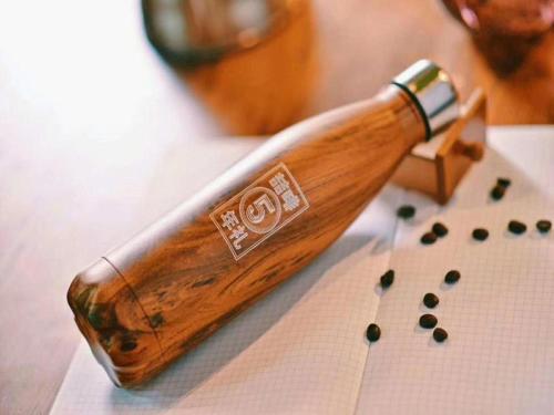 a wooden bottle with seeds on a table at James Joyce Coffetel·Anyang Text Museum in Anyang