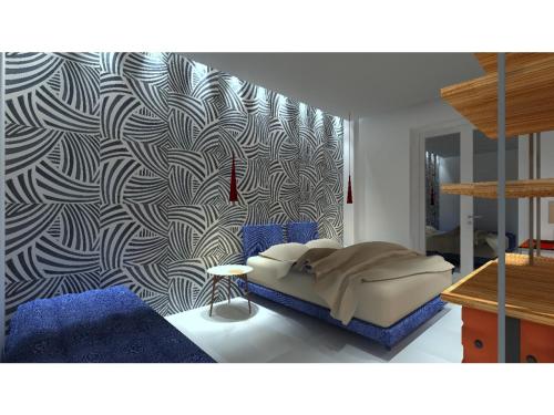 a bedroom with a bed and a patterned wall at B&B Maiori Suites - New opening in June 2024 in Maiori